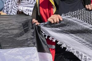Close Up Holding A Flag And A Keffiyeh Shawl At The Student Demonstration Free Palestinian At The UVA University Amsterdam The Netherlands 7-5-2024 photo