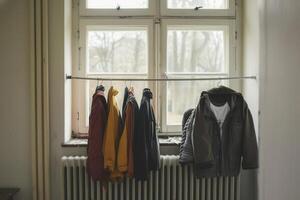 Clothes Hanging on a White Radiator in Room photo