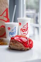 WASHINGTON, USA - August 08, 2024 - A Jack in the Box favorites. The crispy fries,burger, and sodas are ready to satisfy any craving. The bright colors photo