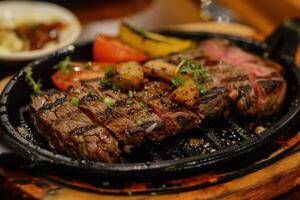 Sizzling Grilled Steak Presented on a Elegant Platter, Offering a Tender and Savory Main Course Experience photo