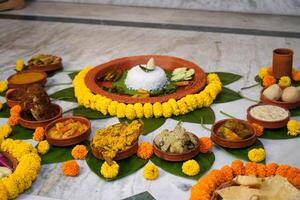 Different types of bengali dishes served in earthenware photo