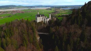 Aerial view Neuschwanstein Castle and bridge Marienbrucke across Pollat gorge in Ammergau Alps. View of famous Neuschwanstein Castle, Fussen, Bavaria, Germany and Marys bridge over cliff video