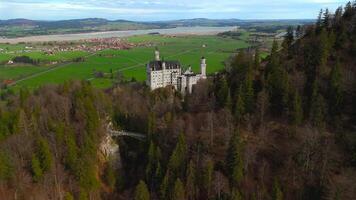 Aerial view Neuschwanstein Castle and bridge Marienbrucke across Pollat gorge in Ammergau Alps. View of famous Neuschwanstein Castle, Fussen, Bavaria, Germany and Marys bridge over cliff video