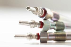 Modern ceramic glow plugs for warming up a diesel engine before starting. White background, isolate. Macro photo