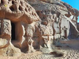 A beautiful view of the caves built into the mountains at the archaeological site of Hegra in Madain Saleh, AlUla in Saudi Arabia. photo