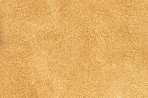 Yellow color abstract textile pattern background. Latte colour fabric material, colored background photo