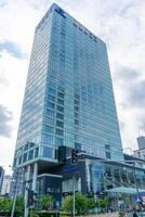 The building and logo of the Polish hotel Hilton Warsaw. Office building skyscraper in the city center. Warsaw, Poland - July 26, 2023. photo