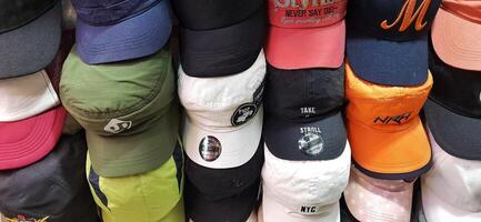 Variety of thrift hats on the display for sale at Pasar Senen. Jakarta, Indonesia - December 11 2024 photo