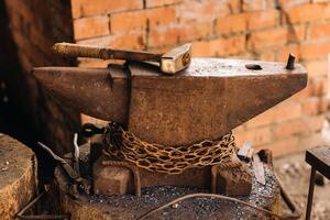 Forge, hammer on an anvil standing on the street photo