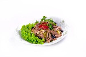 Sliced meat salad with pickled cucumbers and ketchup on an isolated background photo
