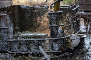 A splash of crude oil that has been taken from an old oil mining well in Wonocolo, Bojonegoro, East Java, Indonesia. photo