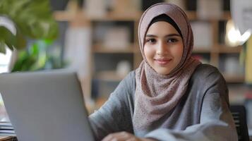 Portrait of a confident and focused young Muslim woman wearing a hijab,working diligently on an engineering project at her desk. She is an empowered digital entrepreneur. photo
