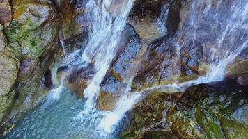 A beautiful and pure waterfall. Water flows in many streams until it becomes a complete and natural waterfall. video