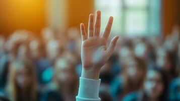 White-sleeved hand raises in classroom environment, representing participation and volunteering against blurred background with warm lighting and educational context. focused photo