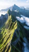 Majestic mountain range draped in lush greenery and clouds photo