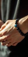 Elegant bracelet adorned with blue stone on a hand photo