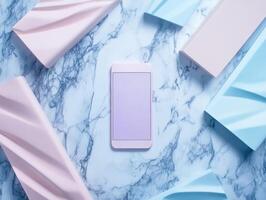 Mobile phone surrounded by pastel geometric shapes on marble photo