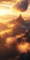 A mountain range with clouds and sun rising over it photo