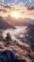 The sun rises over a mountain range with fog and trees photo