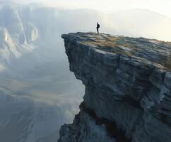 A man stands on the edge of a cliff photo