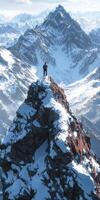 A man standing on top of a mountain with snow photo