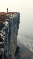 A man standing on the edge of a cliff photo