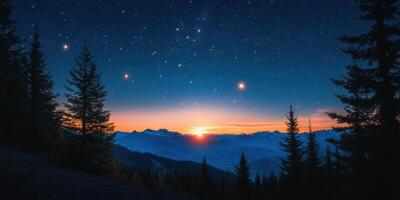 The sun sets over the mountains and stars in the sky photo