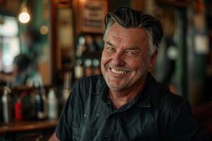 A man smiles while sitting at a bar photo