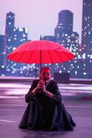 Mysterious Clown Performer with Red Umbrella in Urban Nightscape. photo