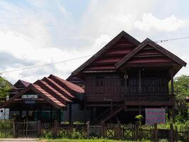 A wide shot of Traditional ethnic house from Soppeng regency South Sulawesi Indonesia with red tile roof no visible people photo