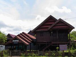 A wide shot of Traditional ethnic house from Soppeng regency South Sulawesi Indonesia with red tile roof in bright sun photo