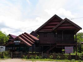 A wide horizontal shot of Traditional ethnic house from Soppeng regency South Sulawesi Indonesia with red tile roof photo