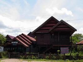 A wide shot of Traditional ethnic house from Soppeng regency South Sulawesi Indonesia with red tile roof photo