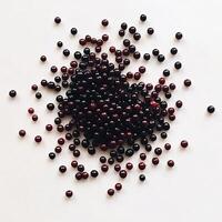 A pile of black and red berries on a white surface photo