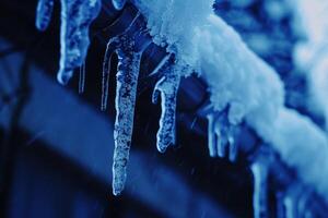 Icicles hanging from the roof of a building photo