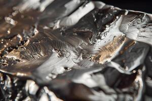 A close up of a piece of foil with silver paint photo