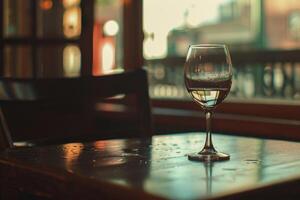 A glass of wine sitting on a table photo