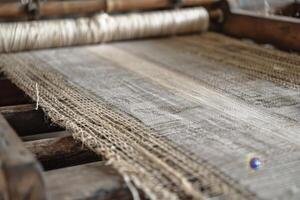 A close up of a weaving machine with a piece of jute photo