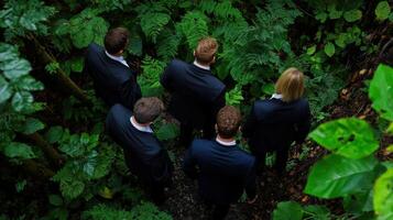 Four men in suits standing in the middle of a forest photo