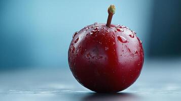 A red fruit with water droplets on it photo
