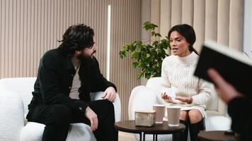 A couple discussing relationship problems at a counseling session with a family psychologist. Concept of Therapeutic services to improve family relationships and resolve conflicts video