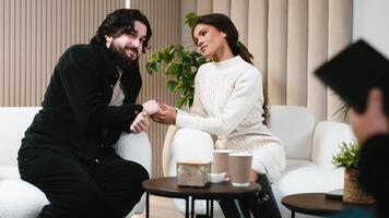 A happy couple at a counseling session with a psychologist shares the results of their success. Concept of successful restoration of relationships through professional and psychological counseling video