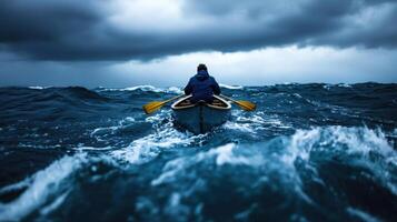 A man in a canoe paddling through rough water photo