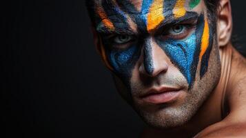 A man with his face painted with colorful paint photo