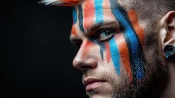 A man with colorful paint on his face photo