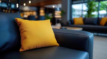 A black leather couch with yellow pillows photo