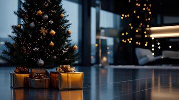 A Christmas tree with gold ornaments sits in front of a room with a few boxes of photo