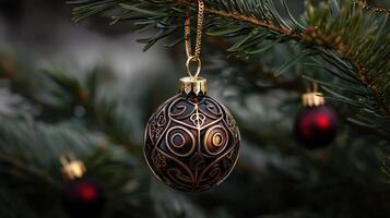 A gold and black ornament hangs from a Christmas tree photo