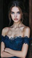 Beautiful young woman in blue dress posing for the camera photo