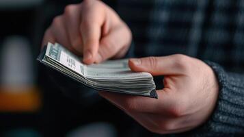 A person holding a wallet with money in it photo